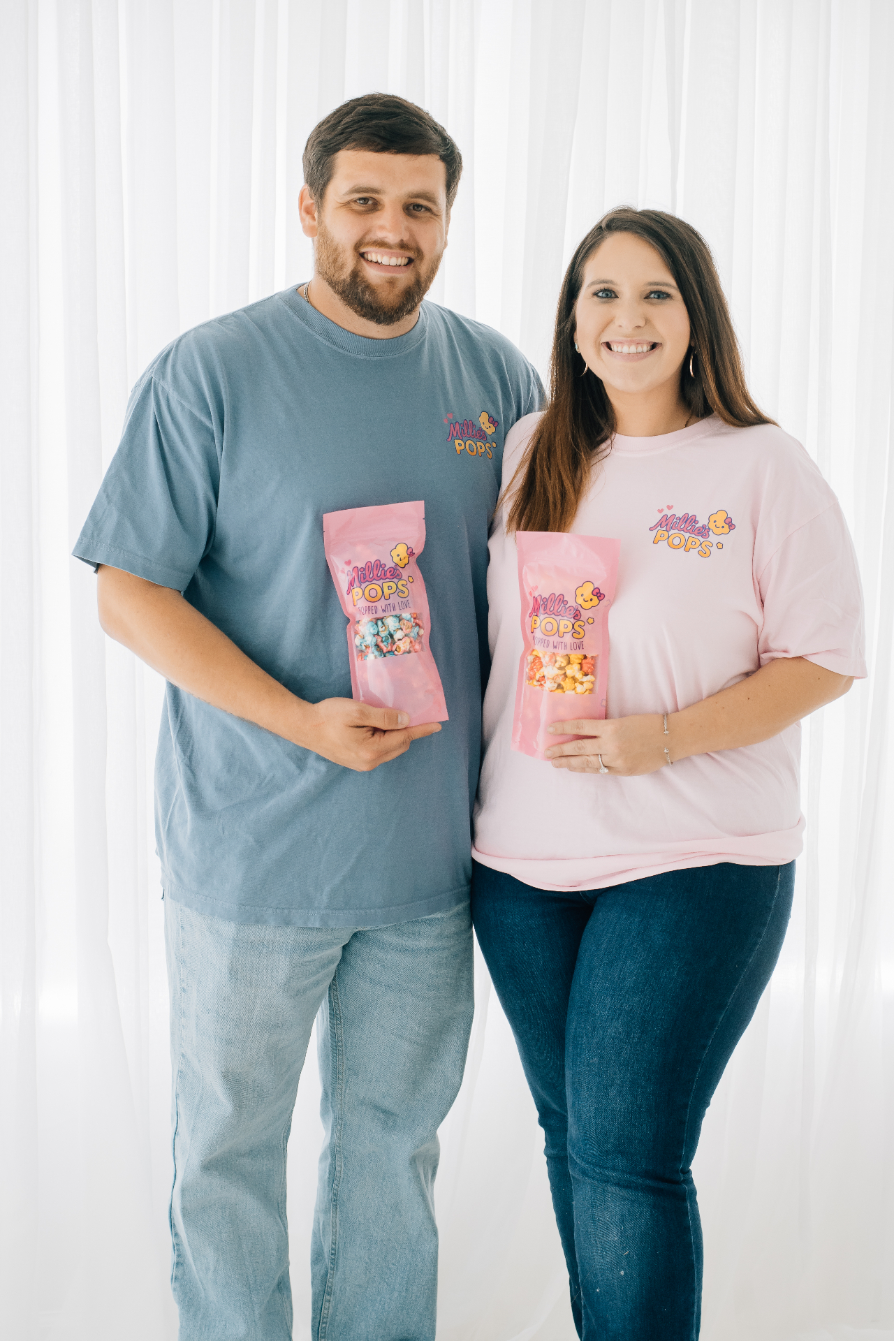 Millie's Pops founders holding popcorn bags