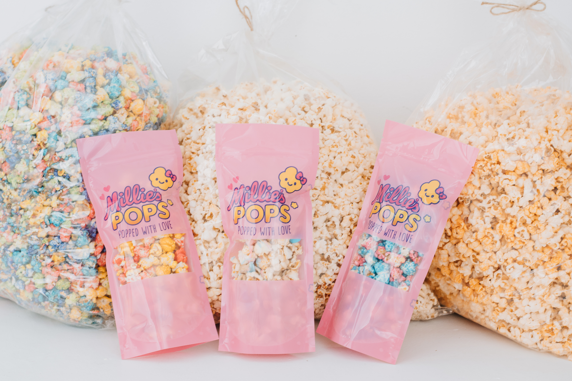 Millie's Pops pink bags with various popcorn flavors